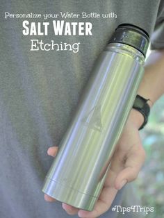 a person is holding a water bottle in their left hand and the words salt water etching on it