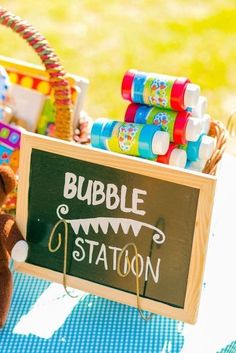 there is a sign that says bubble station next to a teddy bear and other toys