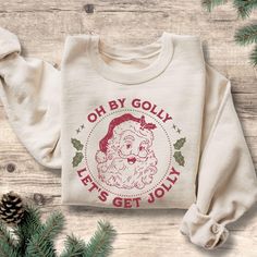 Stay cozy and festive with our Classic Oh By Golly Santa Vintage Sweatshirt, the perfect blend of style and holiday cheer! Whether you're snuggling up by the fire or heading out for winter fun, this cute holiday crewneck adds a pop of color to your seasonal wardrobe. Available for women, kids, toddlers, and babies, it's a heartwarming gift that brings families together during the most magical time of the year. Spread the joy and make unforgettable memories this holiday season with this comfy, st Neutral Christmas Sweaters Colors, Matching Family Shirt, Santa Sweatshirt, Family Shirts Matching, Christmas Crewneck, St Nick, Cozy Night, Family Shirt, Sweater Vintage