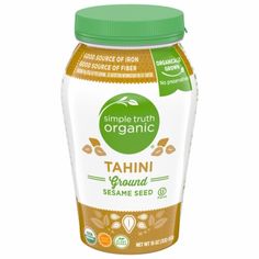 organic tamari seed sesame seed spread in glass jar with green lid on white background