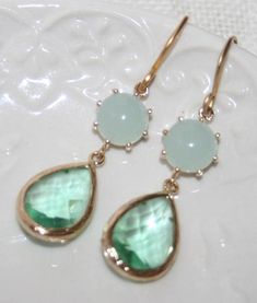 "Seafoam and Erinite Green crystal Teardrop Gold Earrings, Wedding Statement Jewelry, Mint Julep Green pastel Double drop Earrings- Etsy Gift Beautiful and elegant Bridal Airy Seafoam Mint Julep Crystal Teardrop Earrings These are feminine, fabulous looking: wonderful framed Crystal Green Teardrops and pastel pale Mint round Domed connectors - all in Gold plated bezel set Fabulous chic feminine look - These wonderful earrings smartly finish off your look for the elegant everyday or any special o Green Teardrop Earrings For Wedding, Green Teardrop Dangle Earrings For Wedding, Green Teardrop Wedding Earrings, May Birthstone Drop Jewelry For Wedding, Wedding Crystal Earrings For May Birthstone, Wedding May Birthstone Drop Crystal Earrings, Elegant Green Bridal Earrings For Bridesmaids, Green Teardrop Jewelry For Bridesmaid Gift, Elegant May Birthstone Teardrop Earrings