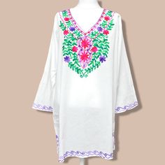 "Vintage Floral Embroidered White Tunic Top Size Large Womens Cotton Blouse Very nice, bright white, 100% cotton with pink, purple and green embroidered chest. A great casual style for summer. Labeled size large 32\" long 20\" sleeves 44\" chest 48\" waist" White Embroidered Summer Top, Summer White Embroidered Top, Multicolor Embroidered V-neck Top For Vacation, Embroidered White Summer Top, Purple Casual Embroidered Top For Spring, Summer Long Sleeve Top With Chikankari Embroidery, Casual Purple Embroidered Top For Spring, Summer Long Sleeve Chikankari Embroidered Top, Long Sleeve Chikankari Embroidered Top For Summer