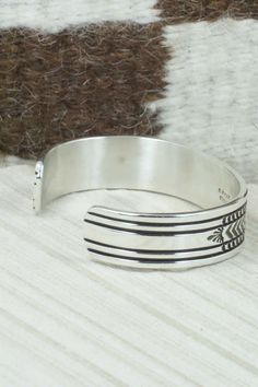 This sterling silver and bracelet was made by Navajo silversmith Bruce Morgan. The inside is signed B. Morgan and stamped sterling.Size: 5 1/4" (will fit up to a 6 3/8" wrist)Gap: 1 1/8"Width: 1/2"Free shipping on all orders! We ship with USPS and always include tracking. All orders ship within a day of payment.Returns are accepted up to 30 days after you receive your order. Just send us a message. Our shop offers cash back or store credit. The item must be returned in new condition. Nickel-free Southwestern Sterling Silver Bracelet, Southwestern Stamped 925 Cuff Bangle Bracelet, Southwestern Sterling Silver Polished Bangle Bracelet, Southwestern Sterling Silver Bangle With Polished Finish, Southwestern Polished Sterling Silver Bangle, Southwestern Silver Cuff Bracelet With Inlay, Silver Inlay Cuff Bracelet Bangle, Adjustable Southwestern Sterling Silver Bracelet, Southwestern Sterling Silver Bracelet Stamped 925 As Gift