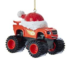 a christmas ornament with a red truck and santa hat on it's head