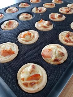 small pizzas sitting on top of a baking tray