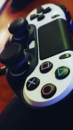 a video game controller sitting on top of a wooden table