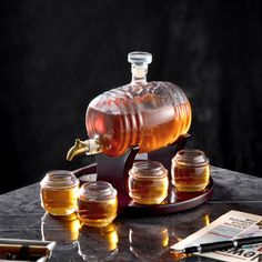 *🥃PREMIUM CRAFTSMANSHIP - Both glasses and decanter are made from 100% safe lead-free borosilicate glass. They are hand-blown by our master artisans in a traditional workshop, ensuring each set is a unique work of art. *🥃LARGE 1350ML CAPACITY - Almost 2 times larger than similar decanters. It can accommodate a bottle and a half of whiskey. It is big enough for most bottles of scotch, bourbon, rum, cognac, wine, brandy, tequila, vodka, and other liquors, while the wide mouth and sturdy spout make it easy to pour and serve. *🥃MEANT TO BE DISPLAYED - The unique design will make it a great addition and decoration to your kitchen, home bar, or liquor cabinet, as well as take your hosting skills to the next level. You'll be proud to own and showcase it while serving your guests. *🥃MAKE AN UN Alcohol Gifts For Men, Liquor Dispenser, Whiskey Decanter Set, Whiskey Gifts, Liquor Decanter, Alcohol Gifts, Whiskey Decanter, Decanter Set, Bar Gifts