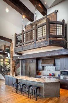 a kitchen with an island and wooden beams