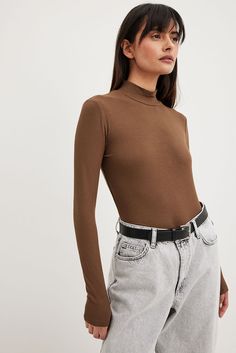 Brown Long Sleeve Sweater With Ribbed Neckline, Brown Stretch Turtleneck Sweater, Brown Ribbed High Neck Sweater, Casual Brown Turtleneck For Fall, Winter Brown Stretch Turtleneck, Brown Ribbed Long Sleeve Sweater, Casual Brown Turtleneck With Ribbed Collar, Casual Ribbed Brown Turtleneck, Brown Ribbed Collar Turtleneck For Fall