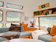 a living room filled with furniture and lots of windows