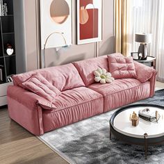 a living room with pink couches and coffee table in front of a large window