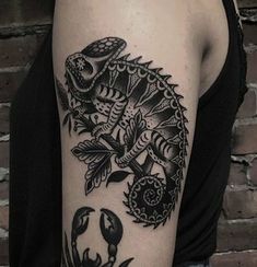 a black and white tattoo on the arm of a woman