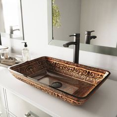 a bathroom sink sitting on top of a counter next to a mirror and faucet