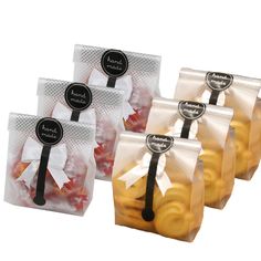 four bags of macaroni and cheese wrapped in cellophane with black ribbon