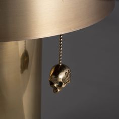 a lamp with a skull hanging from it's side