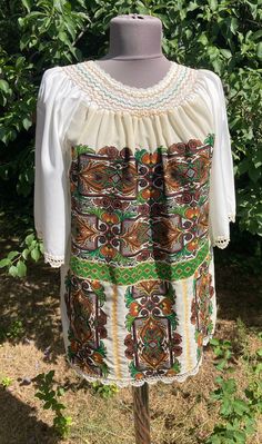 "Vintage  folk cross stiched  handembroidered blouse . Peasant blouse, embroidered blouse, embroidered peasant blouse, floral blouse, ethnic embroidered blouse Beautiful wide shape boho, hippie, folk blouse with floral embroidered pattern.  Handmade blouse Bust : 42\",   110 cm Lenght 27\"  70 cm Hand wash only. If you are buying several pieces I can combine postage at the time of mailing. If you have any question please don't hesitate to contact me,  My etsy shop: https://www.etsy.com/shop/TreasuryCoffer" Folk Style Peasant Tunic Top With Floral Embroidery, Folk Style Peasant Top With Floral Embroidery, Bohemian Embroidered Peasant Top For Spring, Spring Bohemian Embroidered Peasant Top, Spring Bohemian Blouse With Embroidered Hem, Folk Style Embroidered Tunic Top For Spring, Traditional Embroidered Peasant Dress, Spring Bohemian Peasant Top With Embroidered Hem, Summer Folk Peasant Top With Embroidered Sleeves