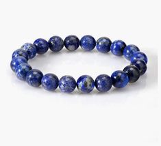 This is a beautiful, genuine Grade A lapis lazuli gemstone stretchy bracelet. This intriguing blue crystal bracelet makes a perfect birthday gift, holliday gift or just a treat for yourself! Lapis Lazuli is a Virgo birthstone and is a highly regarded birthstone known for thousands of years. It is a gemstone believed to attract friends, gain favours and realize hopes. This uplifting bracelet is available in sizes 6 inches to 8 inches (15 cm to 20 cm). It arrives in a sweet jewelry pouch or gift b Sapphire Round Beads Bracelet As Gift, Sapphire Beaded Bracelets For Gifting, Sapphire Gemstone Beads Bracelets, Sapphire Beaded Bracelets As Gift, Sapphire Lapis Lazuli Bracelets As Gift, Sapphire Round Beads Bracelet Gift, Sapphire Round Beads Bracelet For Gift, Sapphire Round Bead Bracelets Gift, Sapphire Beaded Bracelets For Gift