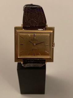 A rare opportunity to acquire a 1965 18k solid gold Omega Geneva gold watch Unusual shape of the case, fully hallmarked for 18k solid gold. This watch is supplied with the iconic Omega 622 caliber movement. Perfect working order and time keeping. After market leather band Original Omega buckle. I will include the original leather Omega band, which is deteriorated due to time. The watch is 29/26mm in dimensions! Hand winding mechanism! Original box! There are some minor blemishes on the 18k gold Formal Yellow Gold Watch Accessories With Rectangular Dial, Timeless Yellow Gold Watch Accessories For Business, Modern Yellow Gold Watch Accessories For Formal Events, Modern Yellow Gold Watch Accessories For Formal Occasions, Antique Yellow Gold Watches For Business, Yellow Gold Watches With Chronometer And Rectangular Dial, Gold Business Jewelry And Watches With Round Dial, Classic Gold Watch Accessories For Formal Occasions, Gold Jewelry And Watches With Round Dial For Business