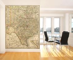 a dining room with a large map on the wall next to a table and chairs