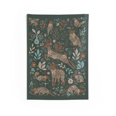 a green and brown wall hanging with deers in the forest on it's side