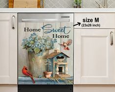 a kitchen with white cabinets and a red cardinal sitting on the counter next to a potted plant