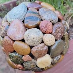 a bunch of rocks sitting on top of each other in a potted planter