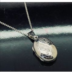 Solid Sterling Silver 925 15mm Etched Oval Locket Pendant Chain Necklace-18" Excellent Workmanship Locket Size: 31mm W/Bail X 15mm Chain Length: 18 Inches Weight: 6.0 Grams Metal: Solid Sterling Silver Hallmark: 925 Very Secure Spring Ring Clasp Please Contact Us If You Have Any Questions. Fast; Free & Secure Shipping Sslktovl60rh-18 9189 Classic White Gold Locket Necklaces, Classic White Gold Locket Necklace, White Gold Oval Link Locket Necklace, Classic Hallmarked White Gold Locket Necklace, Etched Sterling Silver White Gold Necklace, Classic Pendant Locket Necklace For Formal Occasions, Formal Oval Link Engraved Necklace, Formal Engraved Oval Link Necklace, White Gold Jewelry With Sterling Silver Clasp