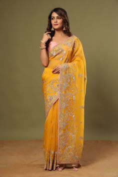 Look royal in this gorgeous mango yellow embroidered organza saree on festive occasions! It comes with a blouse piece. Disclaimer: The actual product may vary slightly from the image. These are custom orders, hence expect slight variation in color, placement of the motif or buta. ESTIMATED DELIVERYBecause this is a custom order, it would take about 4 weeks from the date of purchase. RETURN POLICYThis product is a custom order and cannot be returned or exchanged. Elegant Yellow Organza Pre-draped Saree, Semi-stitched Yellow Organza Pre-draped Saree, Yellow Embroidered Organza Saree, Mustard Yellow Organza Saree, Mango Yellow Saree, Embroidered Sarees, Mango Yellow, Wedding Sarees, Embroidered Organza