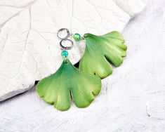 Earrings with leaves of Ginkgo Biloba for lovers of plant jewelry. Large green earrings - good choice for summer, rest and having fun. The earrings are very light and comfortable to wear. This pair will be nice gift for her, especially if she's botanical jewelry lover. Leaves are made by hand from polymer clay, not fragile, strong, not afraid of water. 🍃 Dimensions: Length of earrings 2.75 inches (7 cm) Size of leaf 2.17 * 1.77 inches (5.5 * 4.5 cm) 🍃 Materials: - Polymer clay - Bases for earr Green Leaf-shaped Earrings As A Gift, Ginko Leaf Polymer Clay Earrings, Green Leaf-shaped Jewelry With Matching Earrings, Green Leaf-shaped Earrings For Gift, Green Leaf-shaped Earrings For Pierced Ears, Unique Green Leaf-shaped Jewelry, Handmade Leaf-shaped Nature-inspired Earrings, Nickel-free Green Leaf-shaped Jewelry, Handmade Green Leaf-shaped Earrings