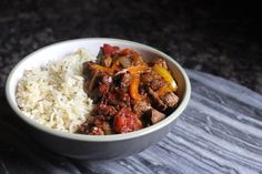 a white bowl filled with meat and rice