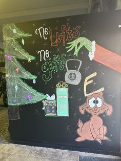 a blackboard with christmas decorations and writing on it