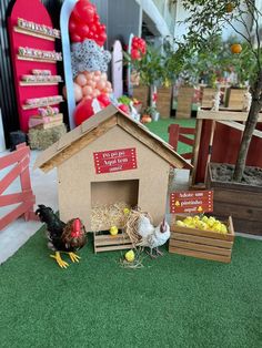 there is a small chicken house with chickens in it and some crates on the ground