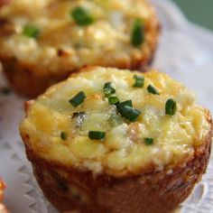 small muffins with cheese and green onions on a white plate