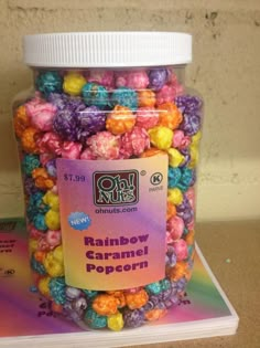 a jar filled with rainbow caramel popcorn