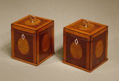 two wooden boxes sitting side by side on a table