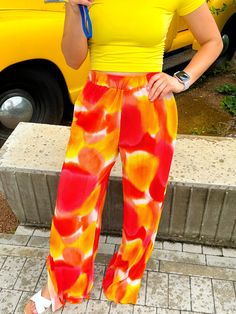 The cutest & comfiest pants you will EVER find!!! The shades of orange and yellow give major sunset vibes and can be styled with SO MANY COLORS!! We love pairing them with pinks, greens, and yellows but TRULY they go with every color!! Style them with a sweatshirt for a casual day or a cute blouse when meeting friends for brunch! True to size with a stretchy waistband 100% Polyester Soft and comfy pants! Style with yellows, pinks, greens, and purples Dress up with a blouse or keep it casual with Vibrant Print Pants For Vacation, Casual Vibrant Print Bottoms For Vacation, Vibrant Print Wide Leg Summer Bottoms, Casual Bottoms With Vibrant Print For Vacation, Wide Leg Bottoms With Vibrant Print For Summer, Casual Vibrant Print Pants For Vacation, Casual Vibrant Print Pants For Summer, Casual Summer Pants With Vibrant Print, Casual Pants With Vibrant Print For Vacation