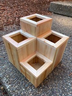 three wooden boxes sitting on the ground