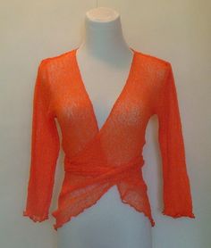 This delicate Knitted Bolero Jacket in stunning Orange color is really a versatile piece.  You can wear it on top of just about anything.  It can pack away very neatly too as it is fine and will not take up much space in your handbag.  Perfect for days out when you feel you may need to cover up a little.    It is perfect for so many occasions. Whether you are going to a beach party or simply going shopping, you will look stylish without effort. It will match any style of outfit as it is both casual and elegant.   One size fits ALL from size S-L  Here is another bolero jacket cardigan in a deeper blue which you may also like http://www.etsy.com/listing/89091515/knitted-bolero-cardigan   All my fashion items are designed and created by me in my atelier in Switzerland. Fitted Versatile Sweater For Spring, Versatile Fitted Sweater For Spring, Versatile Fitted Wrap Cardigan, Fitted Knit Wrap Top, Fitted Fine Knit Summer Sweater, Stretch Knit Wrap Tops, Spring Stretch Knitted Cardigan, Fitted Knit Wrap Cardigan, Fitted Orange Knitted Tops