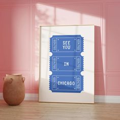 a blue poster with the words see you in chicago on it next to a vase