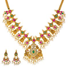 Virani Jewelers unveils radiant splendor with this 22k gold necklace and earring set. A celebration of Indian gold jewelry artistry, this gold jewelry set features a stunning arrangement of emeralds, rubies, and pearls. The intricate design, coupled with the warmth of 22k gold, creates a radiant gold jewelry set that graces your neckline and ears, making a statement of refined taste and cultural richness. Features • 22k yellow gold • Ruby • Emerald • Cubic zirconia • Pearls Necklace Specificatio Luxury 22k Gold Temple Jewelry Emerald Necklace, Festive Yellow Gold Ruby Temple Necklace, Traditional 22k Yellow Gold Emerald Necklace, Luxury Yellow Gold Hand-set Emerald Necklace, Luxury Yellow Gold Ruby Temple Necklace, 22k Gold Necklace, Gold Jewelry Sets, Gold Jewelry Indian, Pearl Gemstone