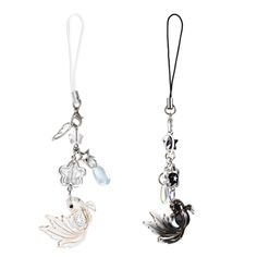 two key chains with charms attached to them on a white background, one has a bird and the other is a fish