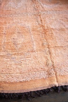 an old rug is laying on the floor with tasseled edges and fringes