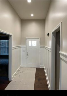 an empty room with white walls and wood flooring is seen in this image from the hallway