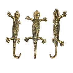 three gold colored lizards are standing next to each other