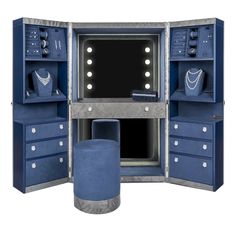 an open blue cabinet with jewelry on it's shelves and lights in the door