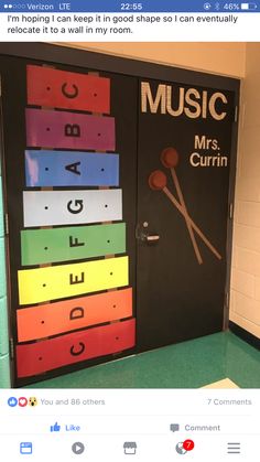 the door to music room is decorated with rainbow colors and musical instruments on it's side