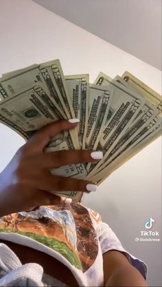 a woman is holding money in her hands