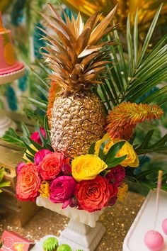 a pineapple surrounded by flowers and greenery