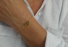 Gold filled peridot bracelet, Green stone bracelet, August birthstone gift This listing is for an elegant peridot bracelet. It comprises a single nugget style peridot bead alongside two gold filled round beads on gold filled chain. The bracelet closes with a gold filled clasp. Peridot gemstone beads are irregular in shape and vary in size. They measure approx 5x6 - 7x9mm and may differ slightly in size and shape than image listing. Made to measure. Please select the measurement from the drop dow Green Stone Bracelet, Peridot Bracelet, August Birthstone, Peridot Gemstone, August Birth Stone, Bracelet Gold, Gold Filled Chain, Green Stone, Bracelet Stack