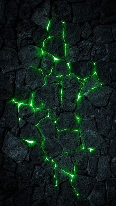 an image of some rocks with green lights on it's sides and the ground